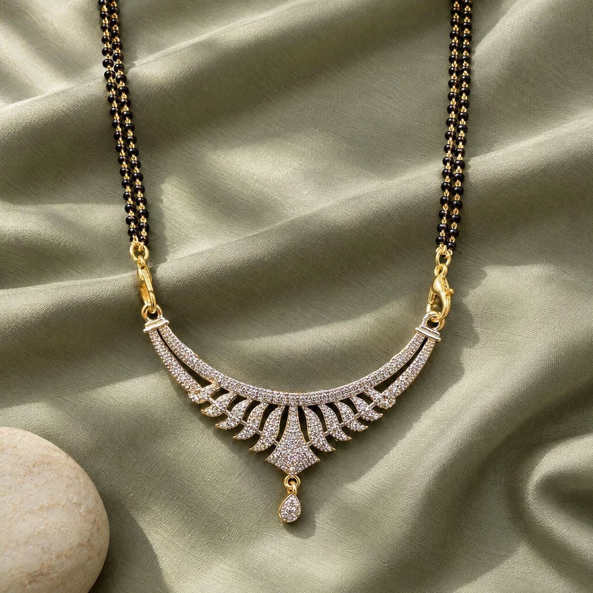 Aavira Grace Crystal Leaf Black Bead Mangalsutra by Oraki Jewels, styled studio view