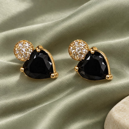 Black Heart Crystal Stud Earrings by Oraki Jewels, styled studio view