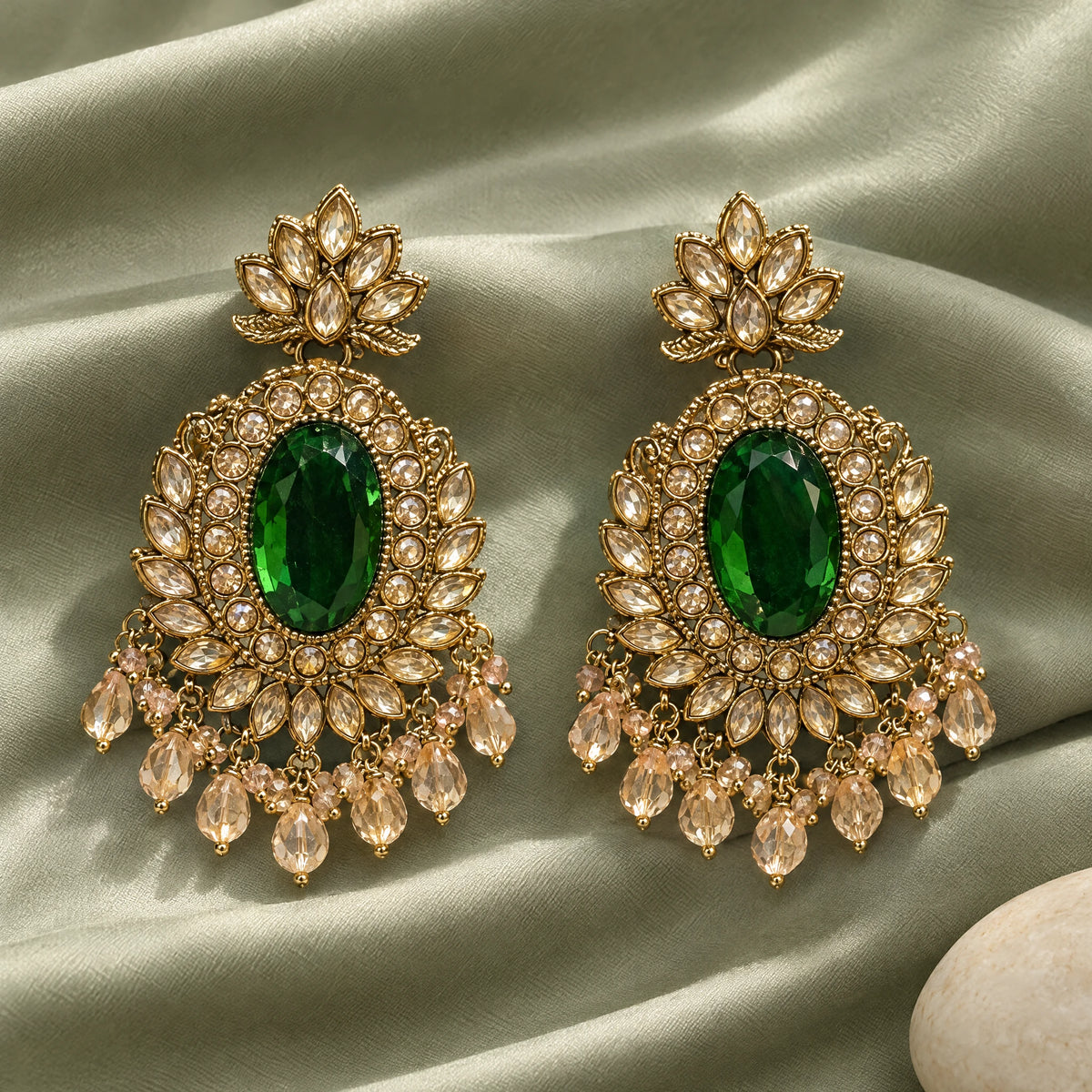 Rajwada Emerald Green Oval Crystal Chandbali Earrings by Oraki Jewels, styled studio view