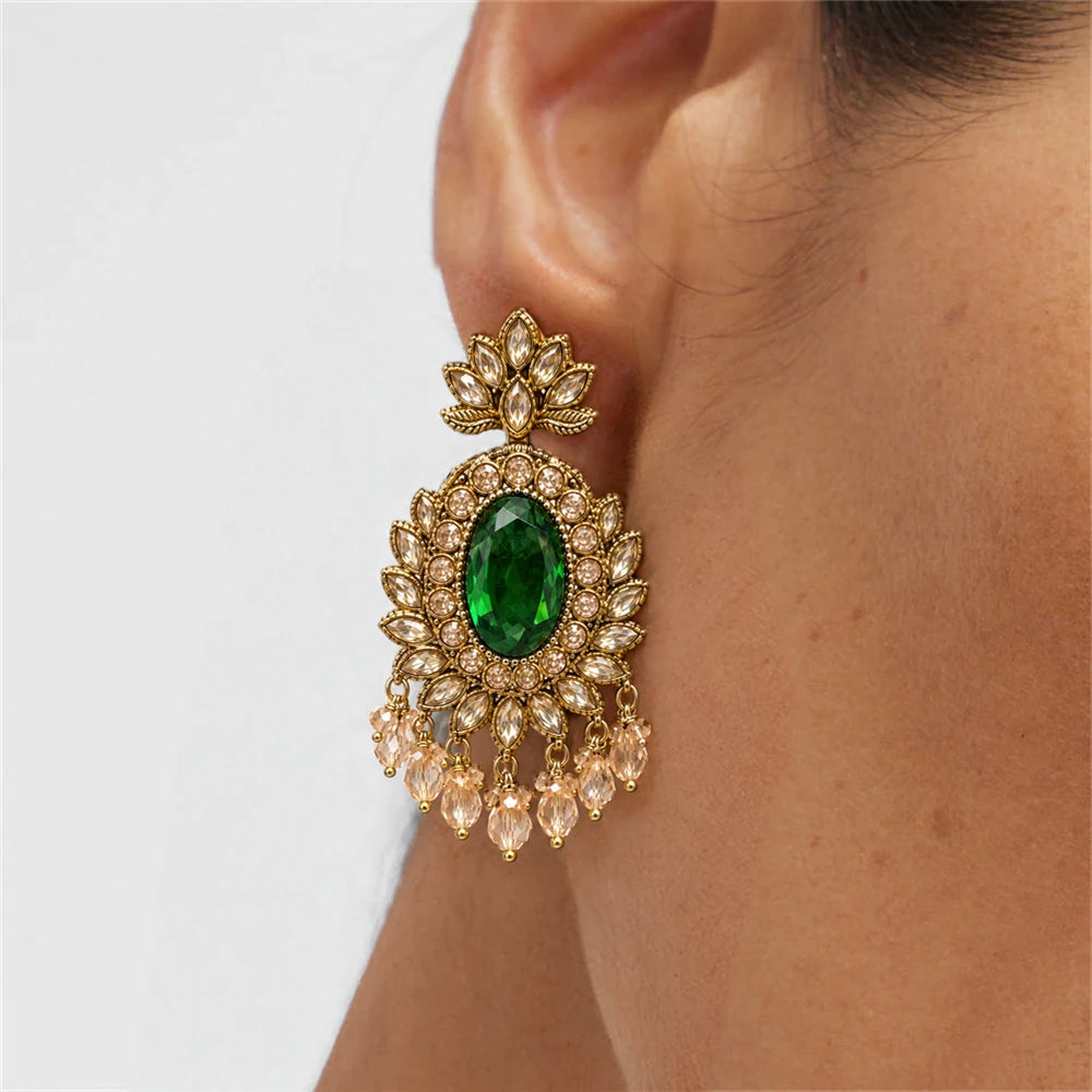 Rajwada Emerald Green Oval Crystal Chandbali Earrings by Oraki Jewels, shown worn for styling