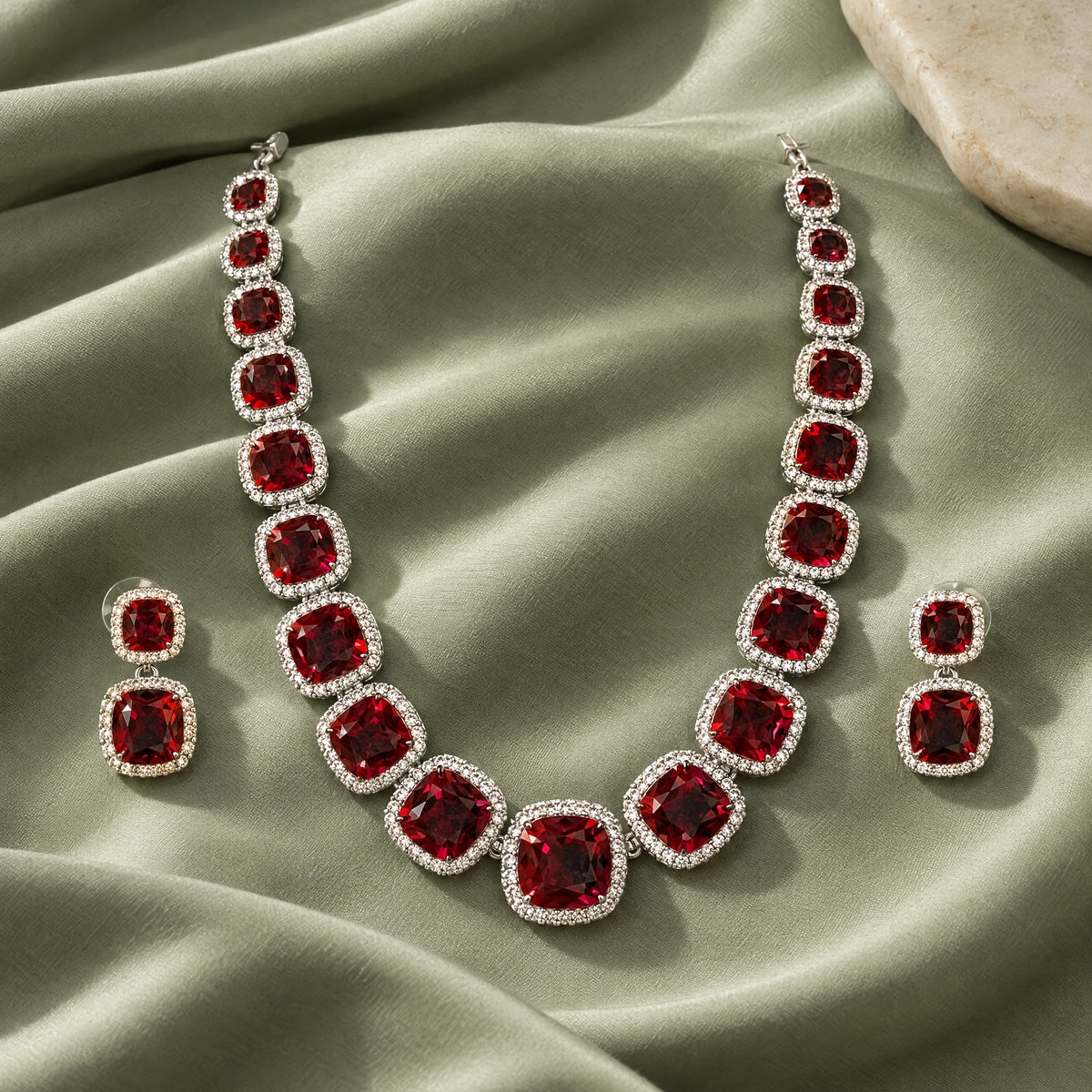 Ruby Red Cushion Tennis Necklace Set by Oraki Jewels, styled studio view