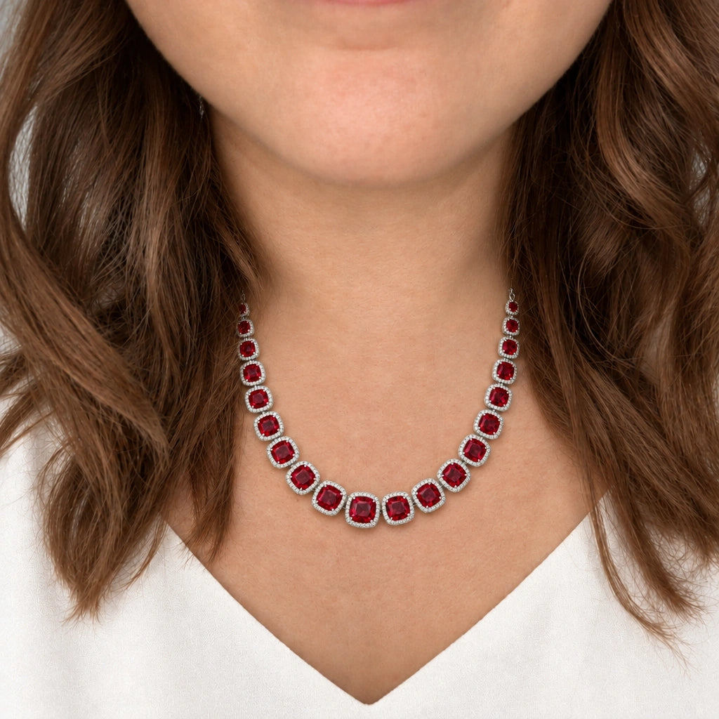 Ruby Red Cushion Tennis Necklace Set by Oraki Jewels, shown worn in a natural studio crop