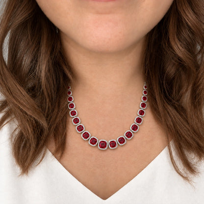 Ruby Red Cushion Tennis Necklace Set by Oraki Jewels, shown worn in a natural studio crop